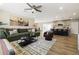 Inviting living room with a comfortable sectional sofa, ceiling fan, and seamless transition to the kitchen at 8640 E Dianna Dr, Scottsdale, AZ 85254