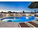 A refreshing swimming pool lit up at twilight is surrounded by lounge chairs for relaxation at 8640 E Dianna Dr, Scottsdale, AZ 85254