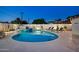 A refreshing swimming pool lit up at twilight is surrounded by lounge chairs for relaxation at 8640 E Dianna Dr, Scottsdale, AZ 85254