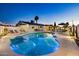 Inviting backyard pool area featuring an in-ground pool, lounge chairs, and manicured landscaping under a twilight sky at 8640 E Dianna Dr, Scottsdale, AZ 85254