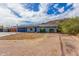 Single-story home featuring desert landscaping and a mountain in the background under a cloudy, blue sky at 9005 E Grandview Dr, Mesa, AZ 85207