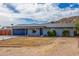 Single-story home featuring desert landscaping and a mountain in the background under a cloudy, blue sky at 9005 E Grandview Dr, Mesa, AZ 85207