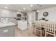 Bright kitchen with gray cabinets, stainless steel appliances, an island and an adjacent dining area at 9005 E Grandview Dr, Mesa, AZ 85207