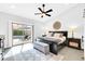 Serene bedroom overlooking the pool, featuring a cozy bed, stylish decor, and natural light at 9739 E Pershing Ave, Scottsdale, AZ 85260