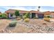 Striking exterior featuring desert landscaping, a tile roof, and a stone lined dry creek bed for optimal drainage at 9739 E Pershing Ave, Scottsdale, AZ 85260