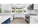 Well-lit kitchen featuring white cabinets, stainless steel appliances, and a large sink with a window view at 9739 E Pershing Ave, Scottsdale, AZ 85260