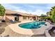 Backyard with a well-maintained pool, sun loungers, and ample patio space, perfect for outdoor entertaining at 9739 E Pershing Ave, Scottsdale, AZ 85260