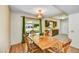 Dining room with wood table set, sliding door to the backyard and kitchen access at 9813 W Pleasant Valley Rd, Sun City, AZ 85351