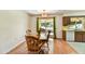 Cozy dining area with wood table set, sliding door to the backyard and kitchen access at 9813 W Pleasant Valley Rd, Sun City, AZ 85351