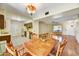 Open dining room with vintage chandelier, adjacent to the kitchen and living room at 9813 W Pleasant Valley Rd, Sun City, AZ 85351