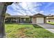 Charming brick home featuring a well-manicured lawn and mature shade tree at 9813 W Pleasant Valley Rd, Sun City, AZ 85351