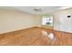 Bright living room featuring a large window, and neutral walls and ceiling at 9813 W Pleasant Valley Rd, Sun City, AZ 85351