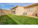 Well-maintained backyard with lush green lawn, block fencing, and covered patio access at 1021 S Greenfield Rd # 1001, Mesa, AZ 85206