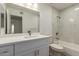 Bathroom featuring a vanity with storage, a spacious mirror, and a tub-shower combination at 1021 S Greenfield Rd # 1001, Mesa, AZ 85206