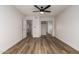 Bedroom showcasing wood-look flooring, ceiling fan, and closet with sliding mirror doors at 1021 S Greenfield Rd # 1001, Mesa, AZ 85206