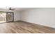 Bright bedroom with wood-look flooring and sliding glass door that leads to the backyard at 1021 S Greenfield Rd # 1001, Mesa, AZ 85206