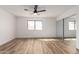 Light and airy bedroom featuring a ceiling fan, mirrored closet, wood-look floors, and a window with natural light at 1021 S Greenfield Rd # 1001, Mesa, AZ 85206