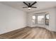 Bedroom showcasing wood-look flooring, ceiling fan, and a bay window for ample natural light at 1021 S Greenfield Rd # 1001, Mesa, AZ 85206