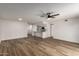Spacious living room with modern ceiling fan and wood-look flooring seamlessly connected to the kitchen at 1021 S Greenfield Rd # 1001, Mesa, AZ 85206