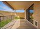 Covered patio includes retractable sun shades, a metal railing, and sliding glass door access to the interior at 1021 S Greenfield Rd # 1001, Mesa, AZ 85206