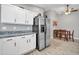 Bright kitchen with white cabinets, stainless steel appliances, granite countertops, and tile flooring at 10733 W Seldon Ln, Peoria, AZ 85345