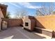 Backyard featuring a cozy fireplace and built-in benches surrounded by brick privacy walls at 1250 E Vermont Dr, Gilbert, AZ 85295
