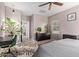 Spacious bedroom with a ceiling fan, plant, and natural light from the window at 1250 E Vermont Dr, Gilbert, AZ 85295