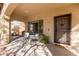 Covered front patio with seating area, security door, potted plants, and a 'hello' welcome mat at 1250 E Vermont Dr, Gilbert, AZ 85295