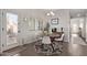Bright dining area with modern light fixture, a dining table and an exterior door with access to a patio at 1250 E Vermont Dr, Gilbert, AZ 85295