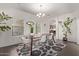 Dining room with modern lighting, stylish furniture, and view into the kitchen area at 1250 E Vermont Dr, Gilbert, AZ 85295