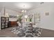 Bright dining room with a modern chandelier, table, and white chairs, complemented by a patterned rug at 1250 E Vermont Dr, Gilbert, AZ 85295