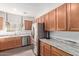 A gourmet kitchen featuring stainless steel appliances, granite countertops, and wood cabinetry at 1250 E Vermont Dr, Gilbert, AZ 85295