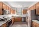Modern kitchen featuring stainless steel appliances, granite countertops, and ample cabinet space at 1250 E Vermont Dr, Gilbert, AZ 85295