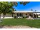 This backyard has a large grassy area with a covered patio at 12633 W Brandywine Dr, Sun City West, AZ 85375