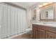 Bathroom featuring a vanity with wood cabinets, tiled floors, and a shower-tub combo at 12633 W Brandywine Dr, Sun City West, AZ 85375