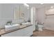 Modern bathroom with dual sinks, wood countertop, and a separate shower with tiled walls at 12633 W Brandywine Dr, Sun City West, AZ 85375