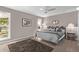 Cozy bedroom with wood floors, a ceiling fan, and a large window offering natural light at 12633 W Brandywine Dr, Sun City West, AZ 85375