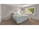Serene bedroom with plush carpeting, ceiling fan, and a large window overlooking the neighborhood at 12633 W Brandywine Dr, Sun City West, AZ 85375