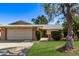 Charming single-Gathering home with a lush green lawn, mature trees, and a welcoming two-car garage at 12633 W Brandywine Dr, Sun City West, AZ 85375