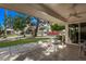 Relaxing covered patio with tiled floor, ceiling fan, and outdoor furniture overlooking a serene backyard at 12633 W Brandywine Dr, Sun City West, AZ 85375