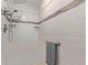 Tiled shower with bench, rainfall shower head, and a built-in shelf for bath products at 12633 W Brandywine Dr, Sun City West, AZ 85375