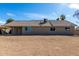 Back exterior view of home with spacious backyard and covered patio at 1318 E Mission Grande Ave, Casa Grande, AZ 85122