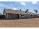 Back exterior view of home with spacious backyard and covered patio at 1318 E Mission Grande Ave, Casa Grande, AZ 85122