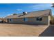 Back exterior view of home with spacious backyard and covered patio at 1318 E Mission Grande Ave, Casa Grande, AZ 85122
