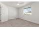This bedroom features neutral carpet, a ceiling fan, and window views at 1318 E Mission Grande Ave, Casa Grande, AZ 85122