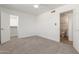 This bedroom features neutral carpet, a ceiling fan, and en-suite bathroom at 1318 E Mission Grande Ave, Casa Grande, AZ 85122