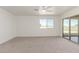 Bright bedroom showcasing carpet floors, a ceiling fan, and a sliding door to the patio at 1318 E Mission Grande Ave, Casa Grande, AZ 85122