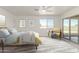 Staged bedroom with neutral tones, carpeted floor, natural light, and patio access at 1318 E Mission Grande Ave, Casa Grande, AZ 85122
