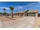 Well-maintained single-story home with desert landscaping, a tiled roof, and an attached two-car garage at 1318 E Mission Grande Ave, Casa Grande, AZ 85122