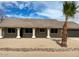 Charming front exterior with elegant columns, desert landscaping, and a two-car garage at 1318 E Mission Grande Ave, Casa Grande, AZ 85122